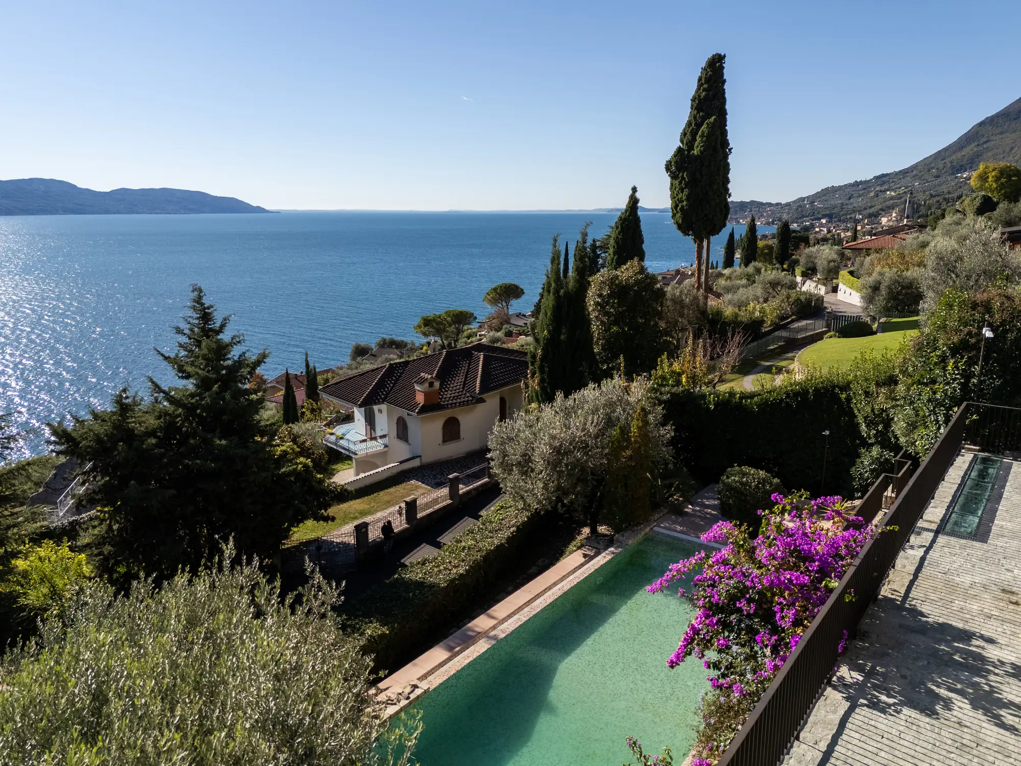 Panoramic view over the pool, bougainvillea and Lake Garda from Villa Giulia